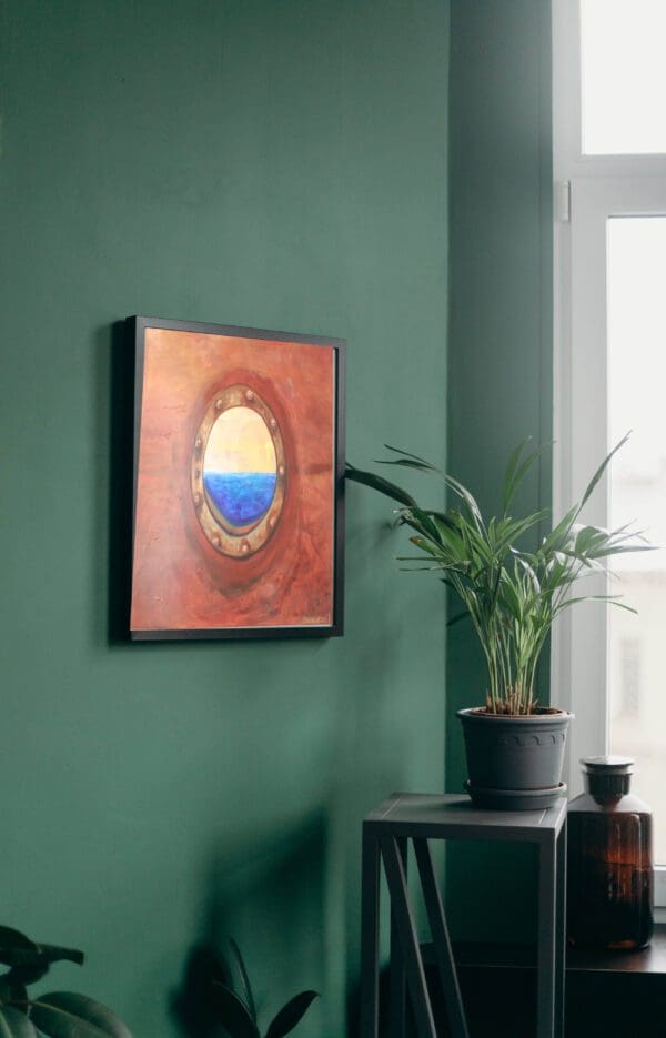 A painting of the ocean on a wall next to a plant.