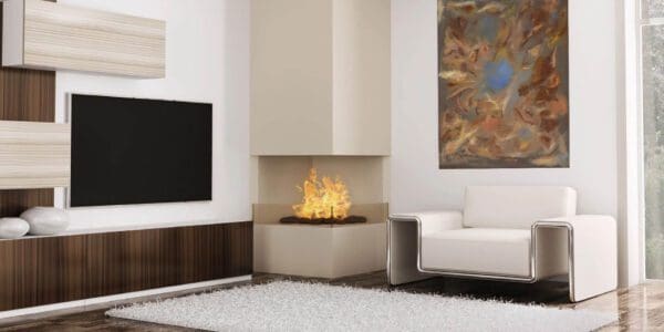 A corner fireplace in the center of a living room.