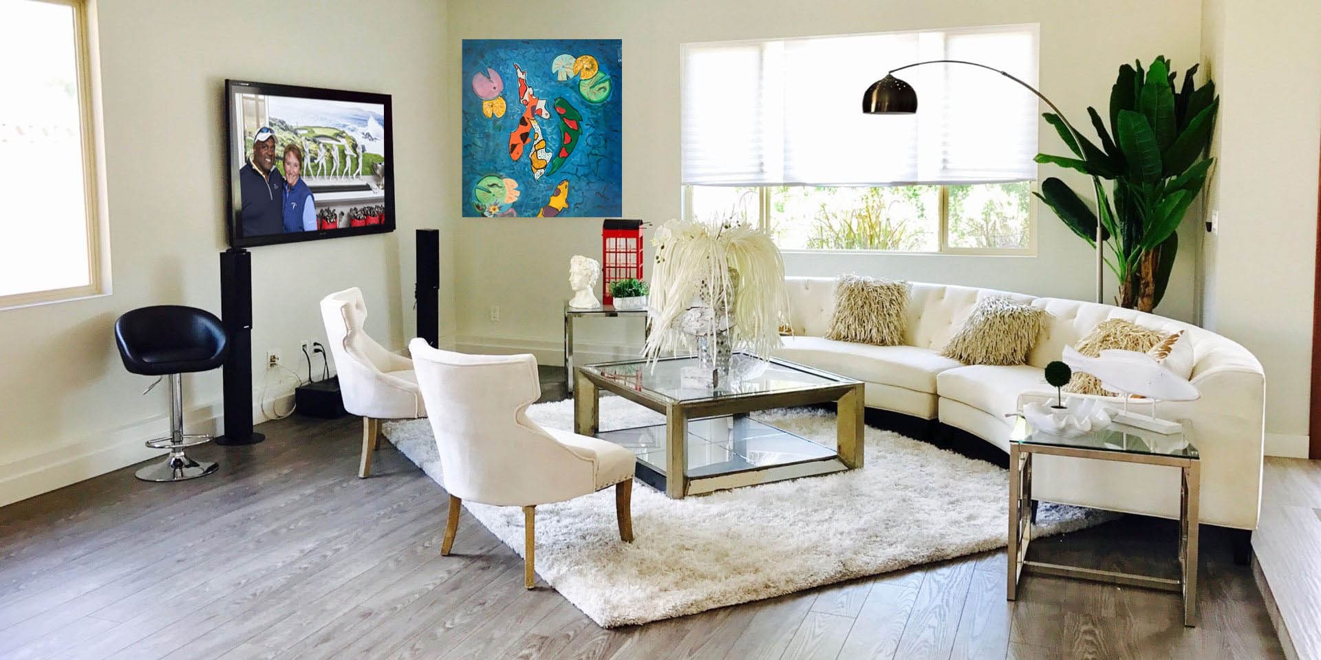 A living room with white furniture and a rug.
