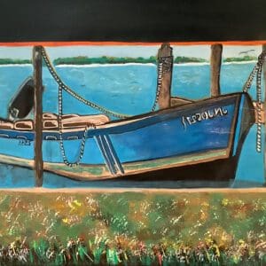 Blue boat docked at wooden pier.
